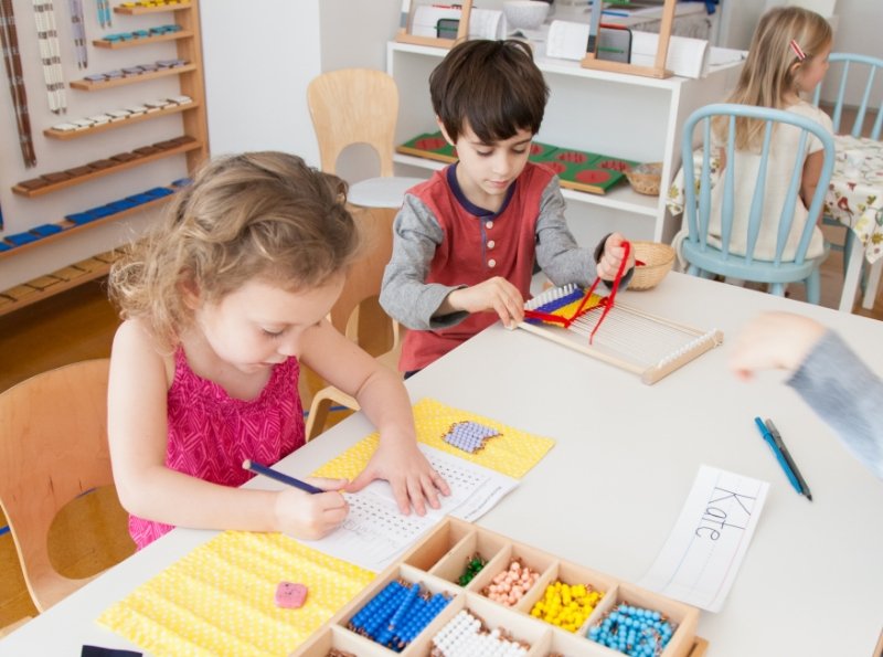 two REDS students using beads