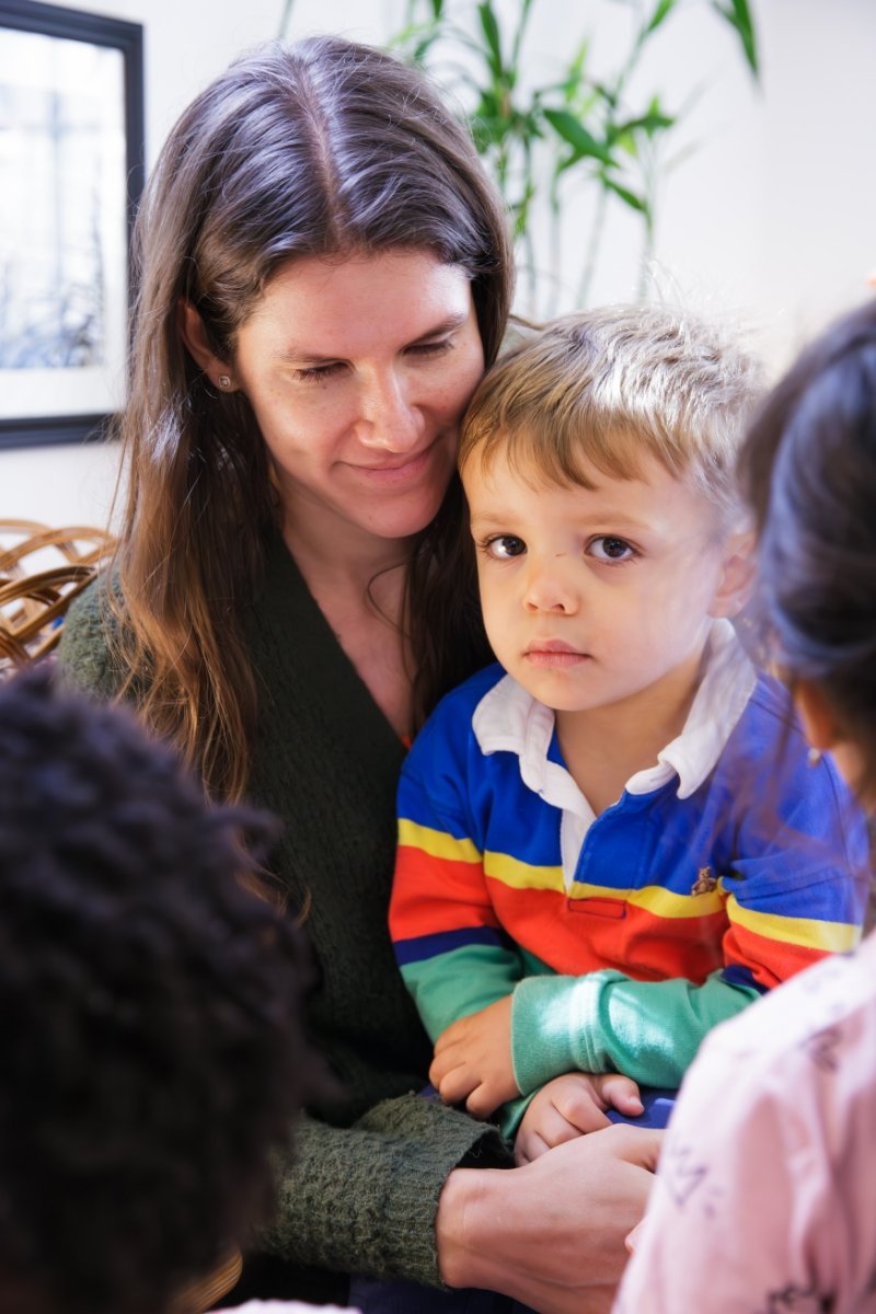 student sitting in teachers lap