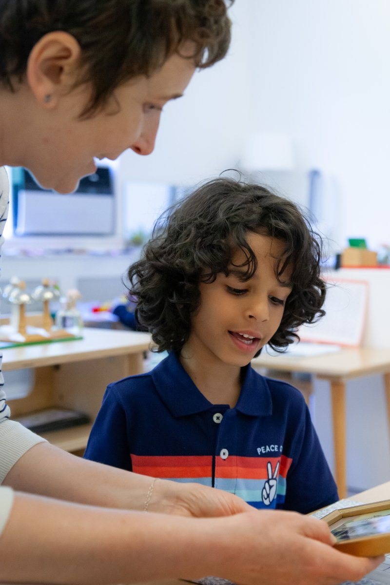 student reading with teacher