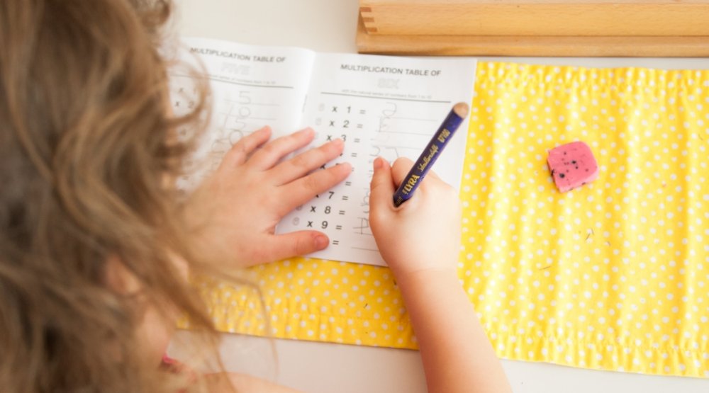 student working on math worksheet