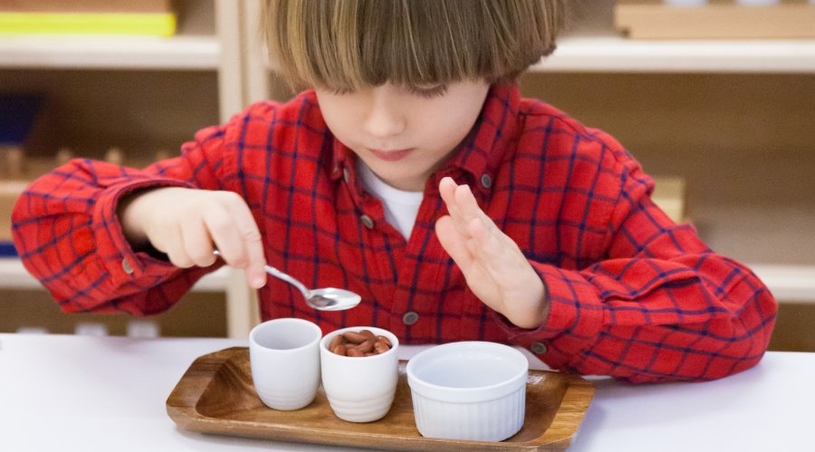 student sorting small items into 3 containers