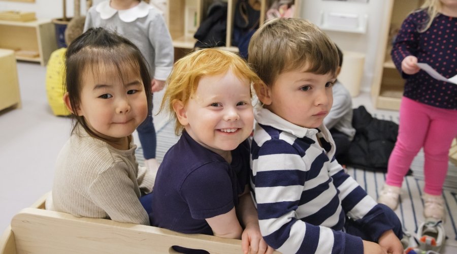 three toddler students sitting together